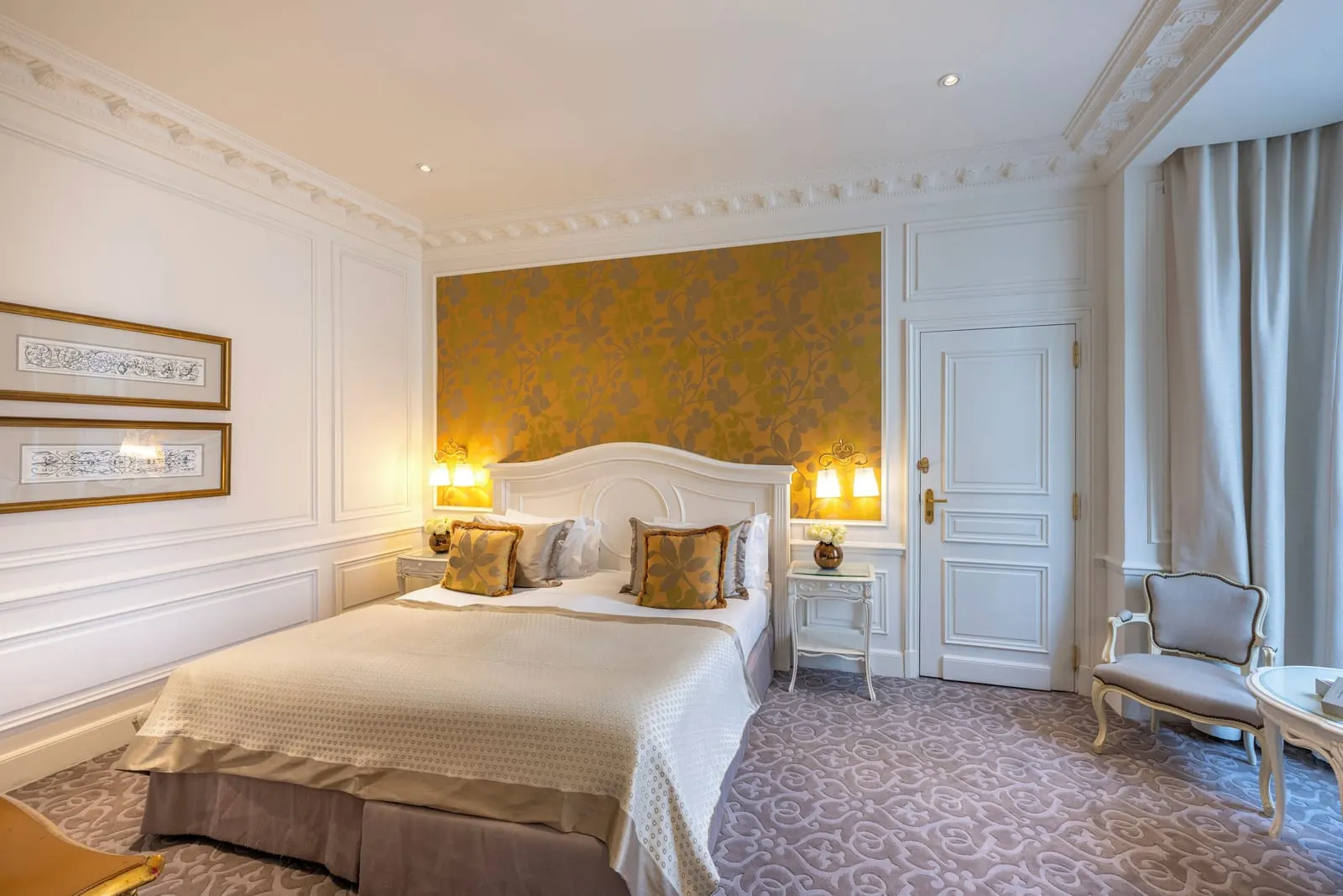 Superior King Room at Hôtel Hermitage Monte-Carlo: the bed against a gold damask wall panel, with an armchair by the window