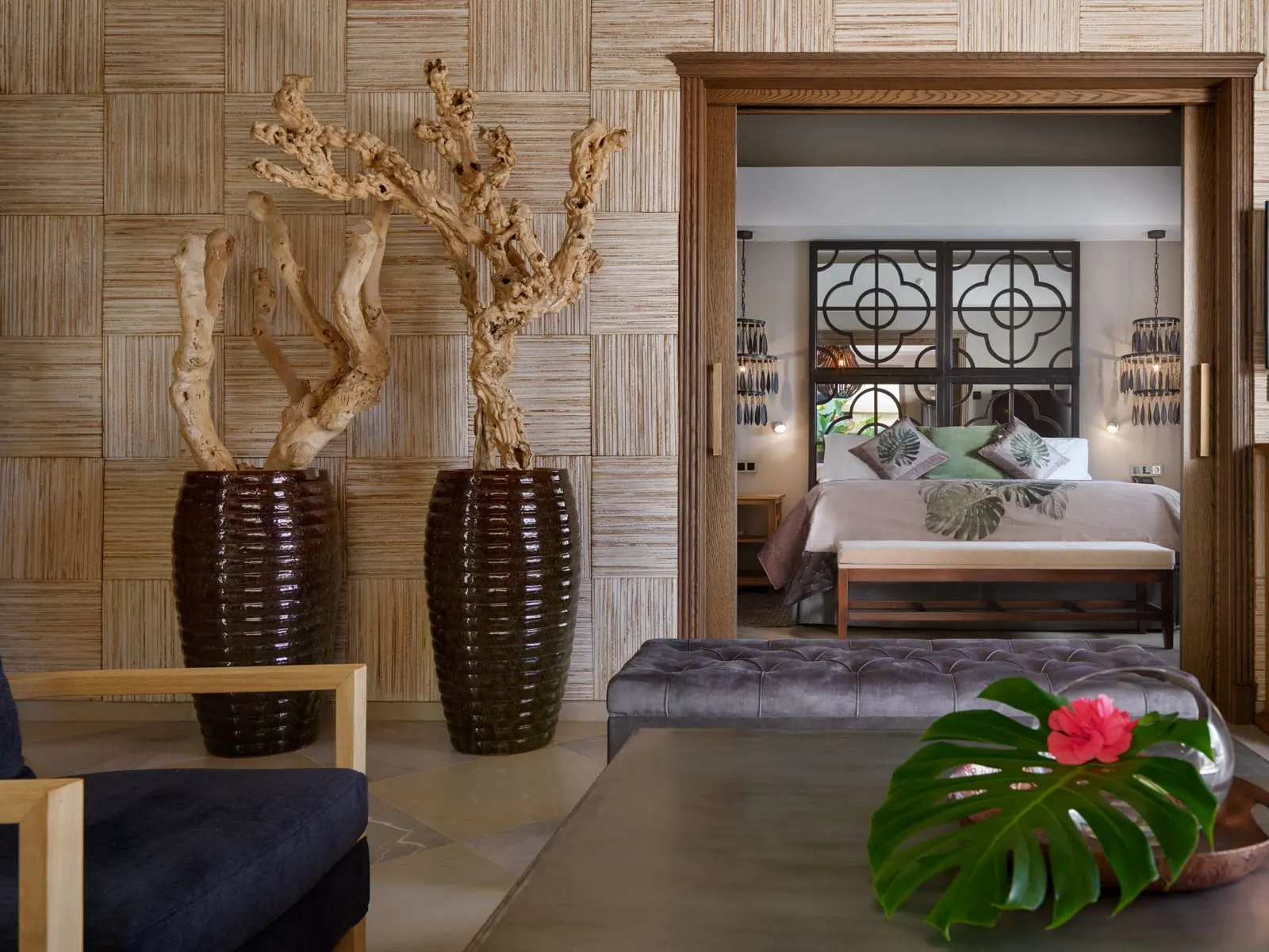 Two-bedroom Grand Pool Villa at Royal River: a bedroom seen through a doorway past two tall vases