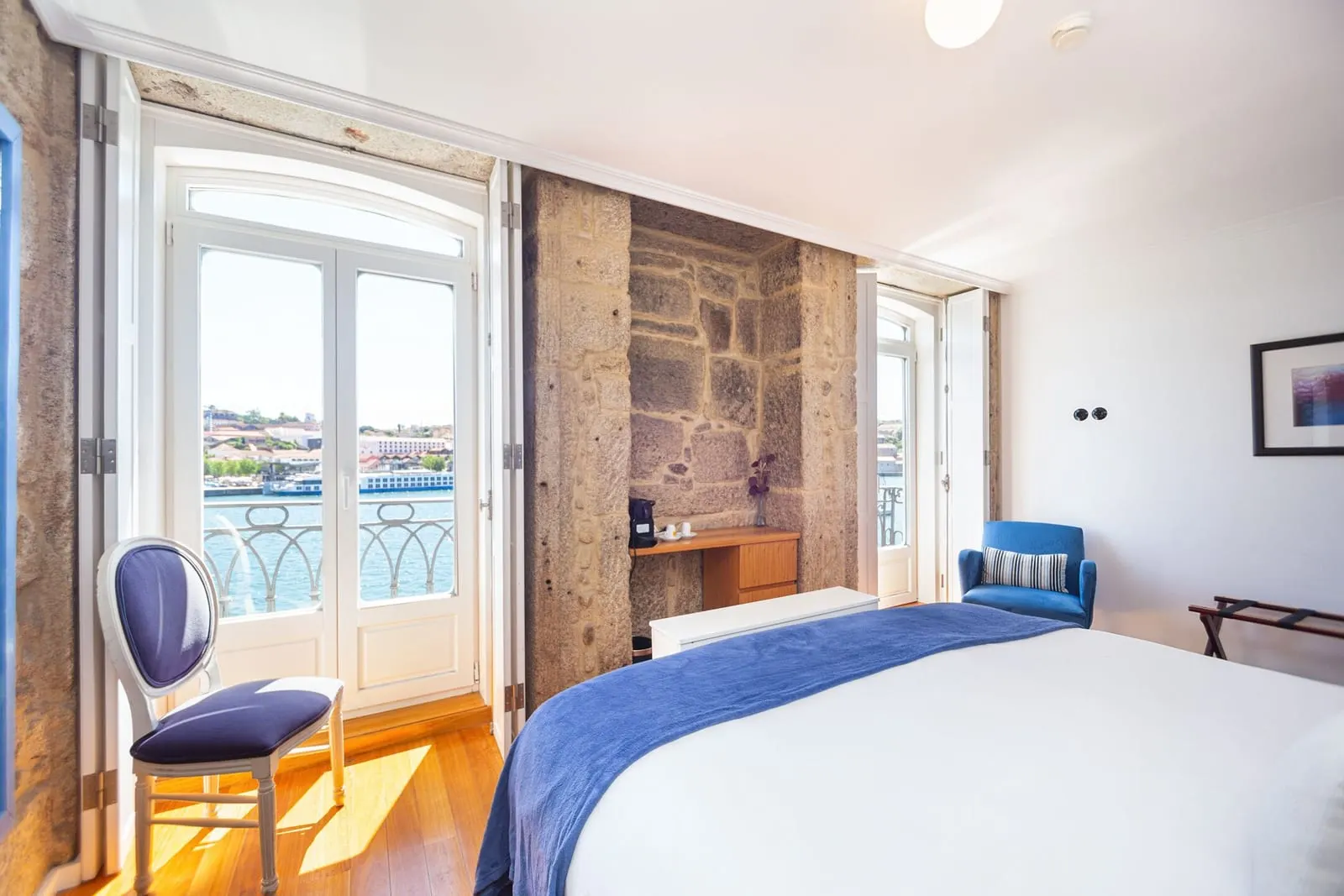 Superior Room with River View at 1872 River House: the bed facing two pairs of glazed doors onto the Douro