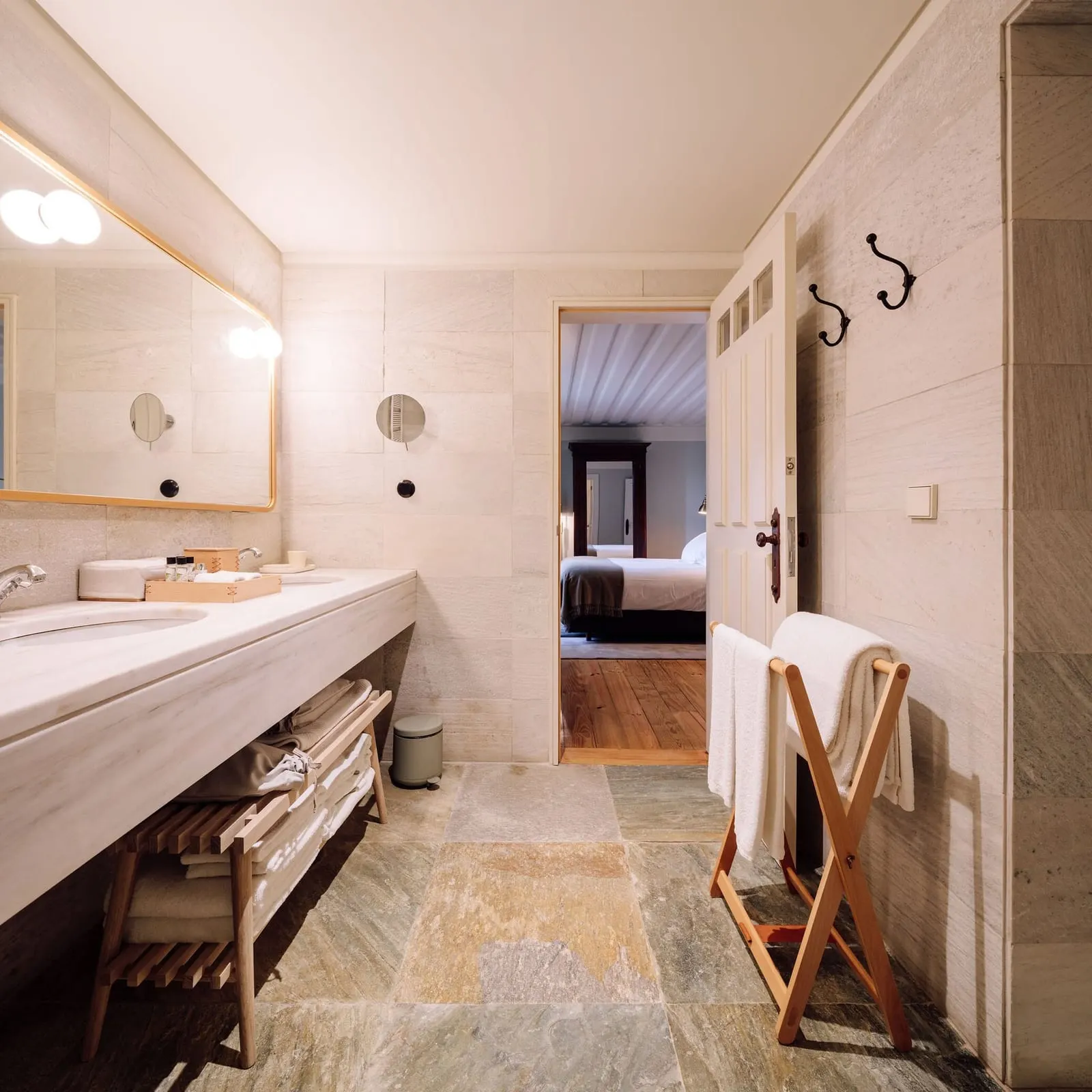 Premium Manor House Accommodation bathroom at Quinta Nova: a long double vanity, a stone floor and a wooden towel stand