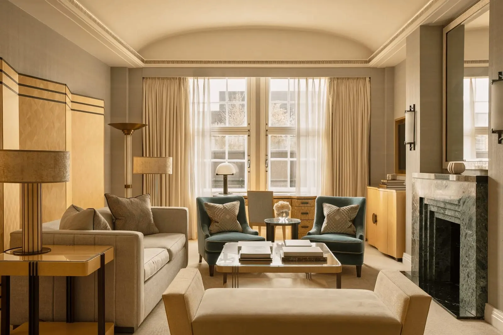 Two Bedroom Claridge's Suite at Claridge's: the living room with a green marble fireplace, a sofa and two teal armchairs