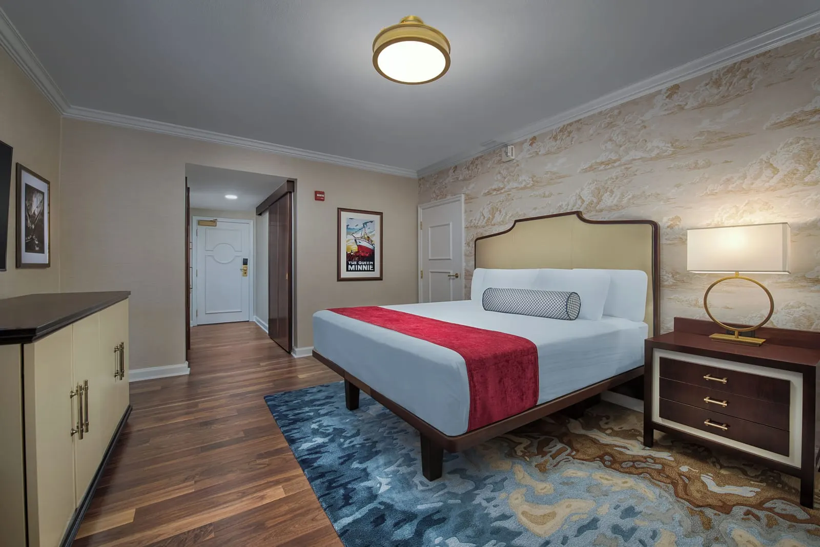 2 Bedroom Suite - Club Level Access im Disney's Yacht Club Resort: eines der Schlafzimmer, mit einem Kingsize-Bett, einem Nachttisch mit Lampe und einer Kommode