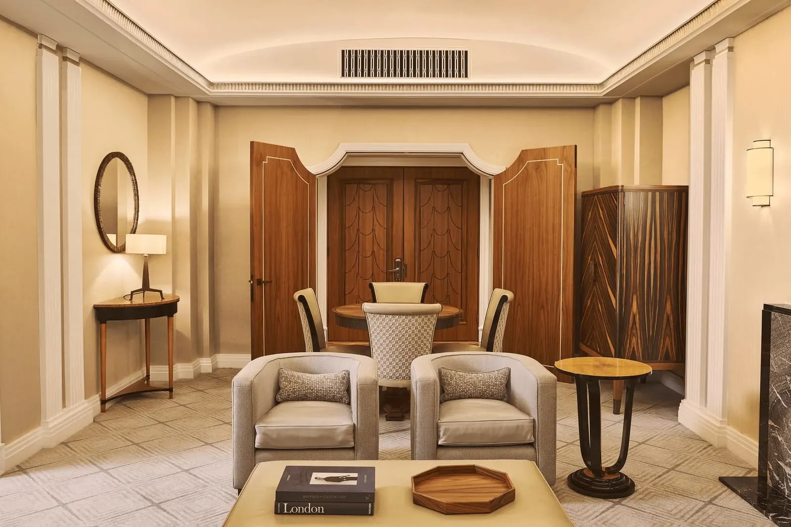 Claridge's Suite at Claridge's: the living room with two armchairs, a round table and wood-panelled doors