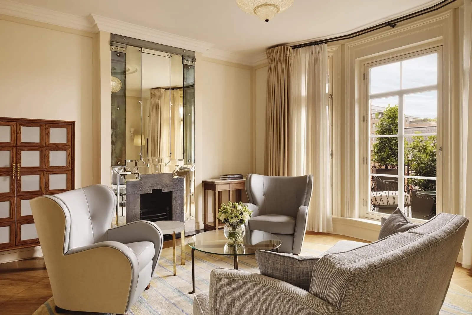 Mayfair Terrace Suite at Claridge's: the sitting room with a fireplace, armchairs, a sofa and tall windows