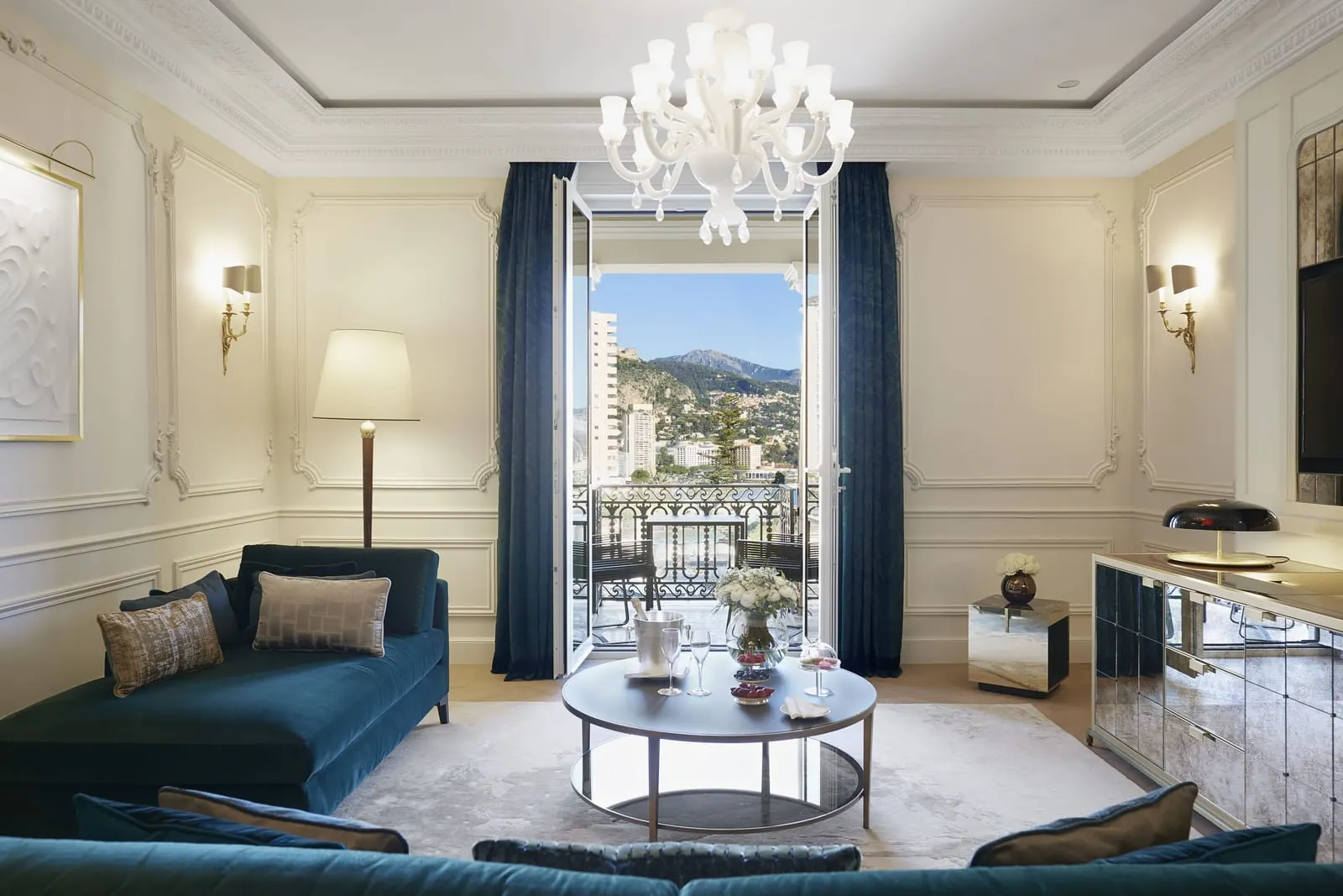 Suite with casino view at Hôtel de Paris Monte-Carlo: the sitting room with blue sofas and French windows open to a balcony