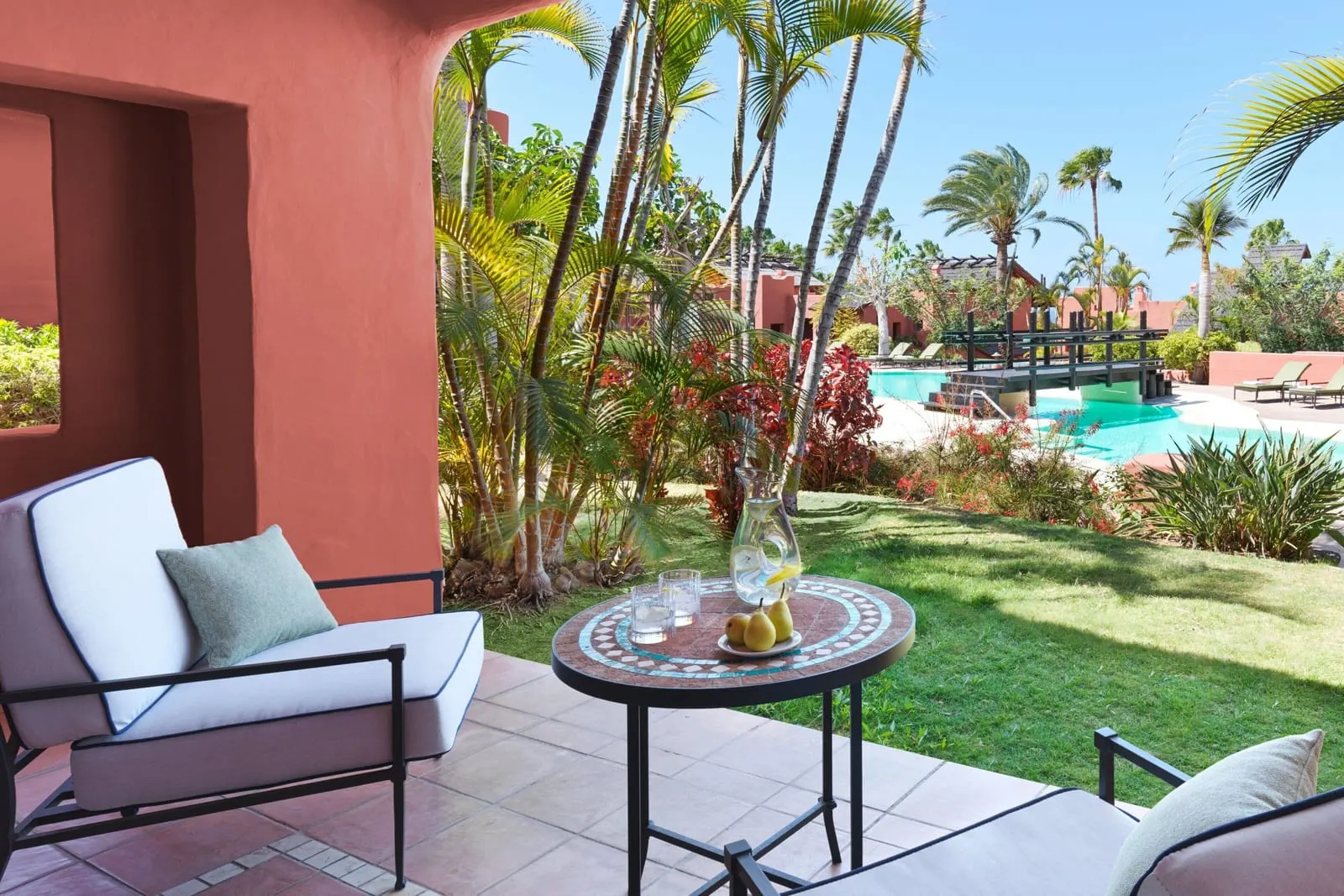 Retreat Deluxe Room, Adults Only, Garden View at the Ritz-Carlton Abama: a terrace chair and table on the lawn, a pool beyond