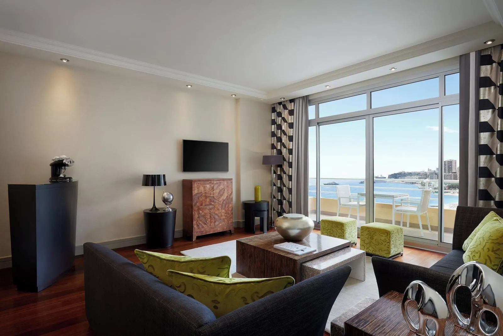 Executive Suite at Le Méridien Beach Plaza: the living room with sofas and glass doors to a terrace over the sea