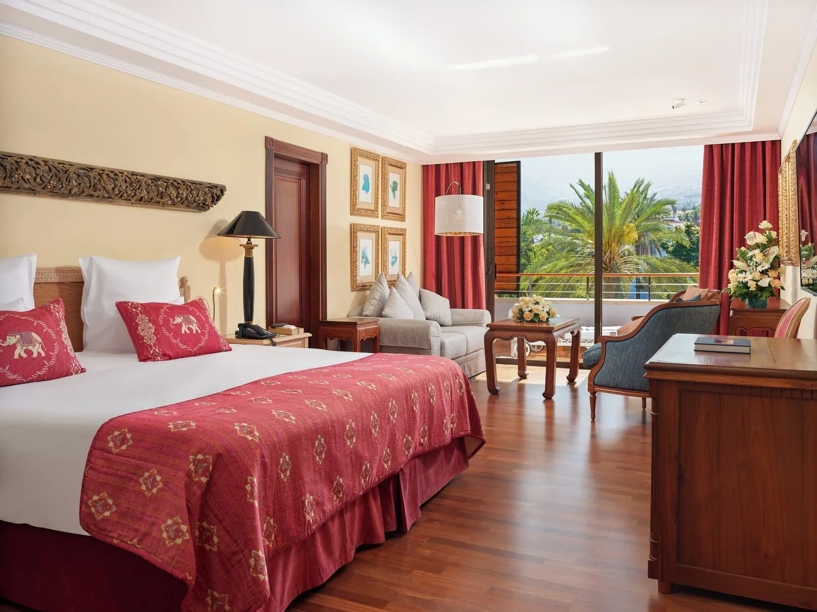 Superior Deluxe Teide View at Hotel Botánico: a king bed, a sofa and armchairs, with a window onto palms