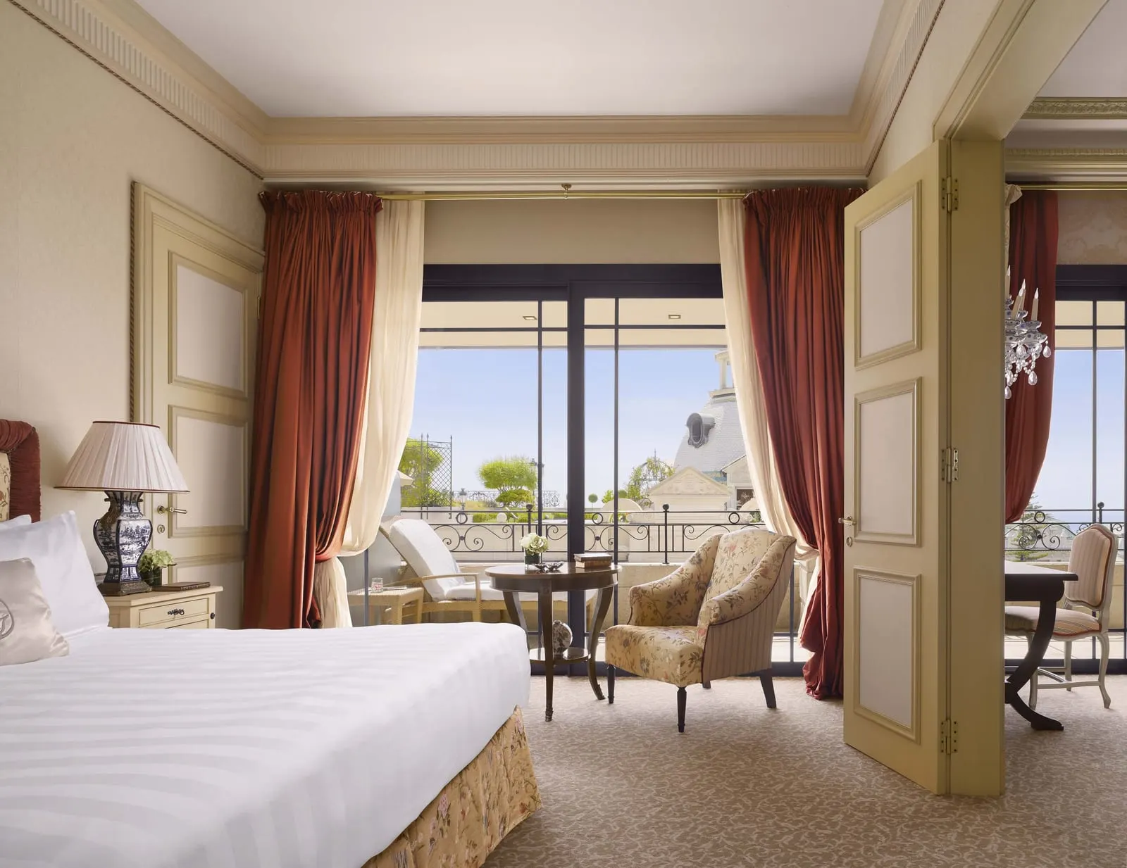 Prestige Suite at Hôtel Métropole Monte-Carlo: the bedroom, with doors open to the lounge and French windows to the terrace