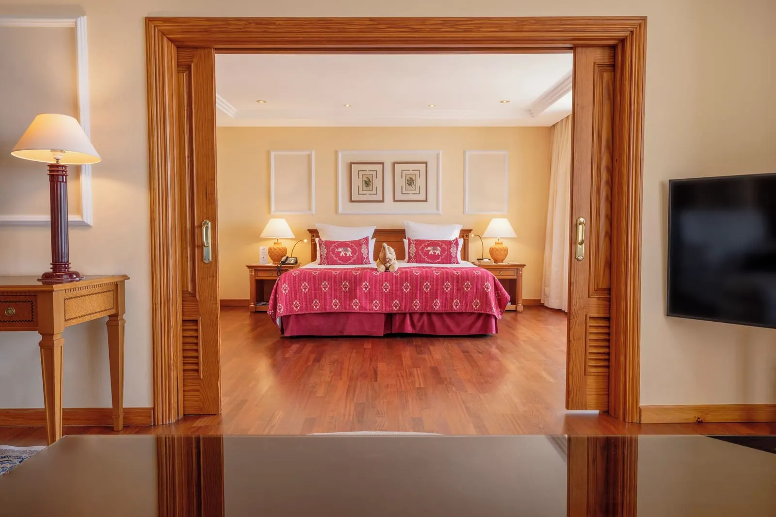 Senator Suite Ocean View at Hotel Botánico: the bedroom, twin beds with pink covers, seen through a wide doorway