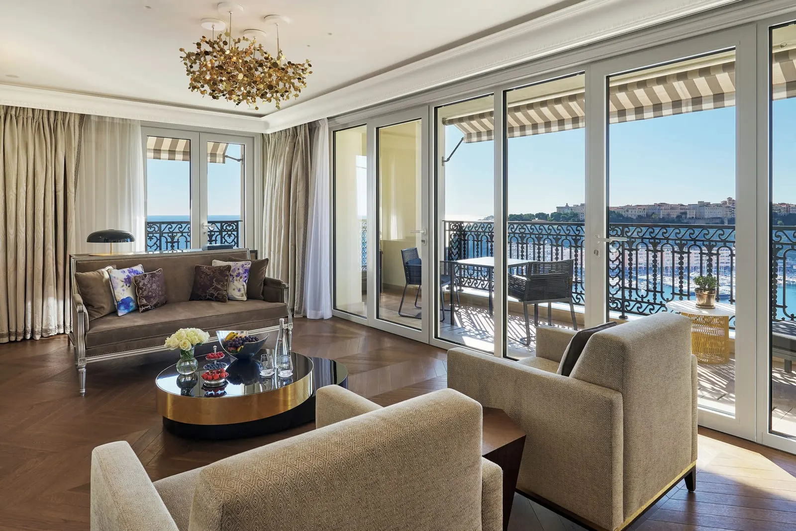 Corner Suite at Hôtel de Paris Monte-Carlo: the sitting room, with glass doors to a balcony over the harbour and the Rock