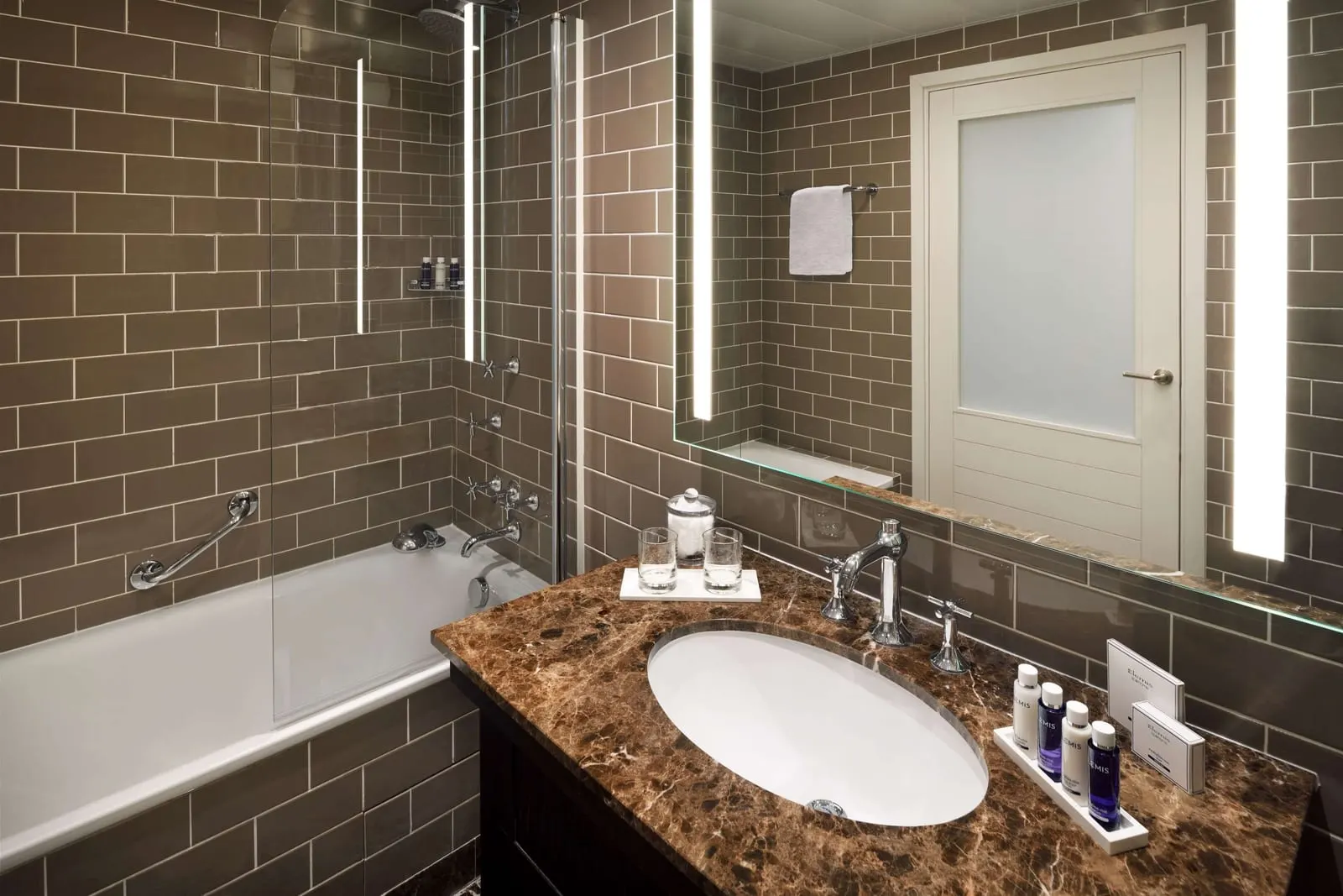 Riviera Deluxe Room at Columbus Hotel Monte-Carlo: the bathroom with a bathtub and a brown marble basin