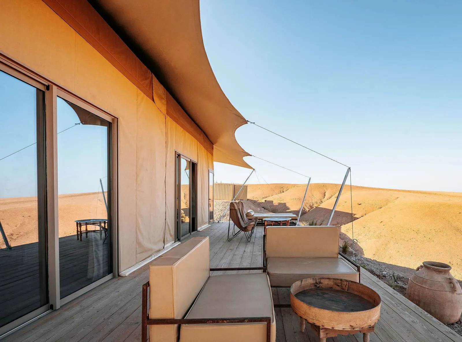 Inara Camp: A tent's wooden terrace above the desert