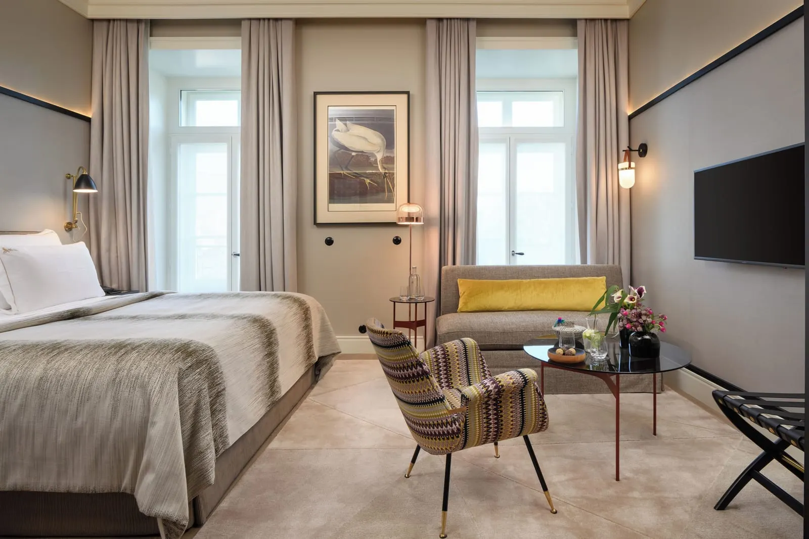 Prestige Tejo room at Bairro Alto Hotel: the bed, a sofa, a striped armchair and two tall windows