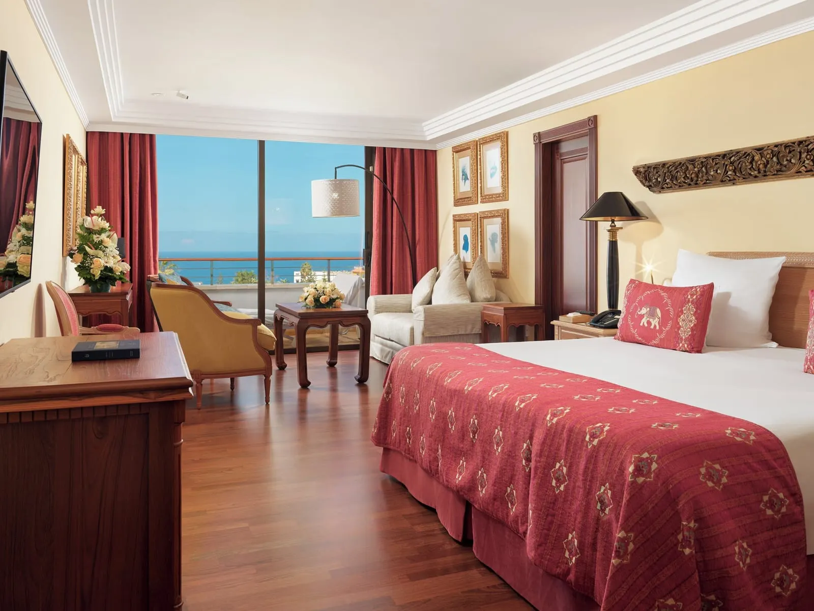 Superior Deluxe Ocean View at Hotel Botánico: a king bed, armchairs and a window onto the sea