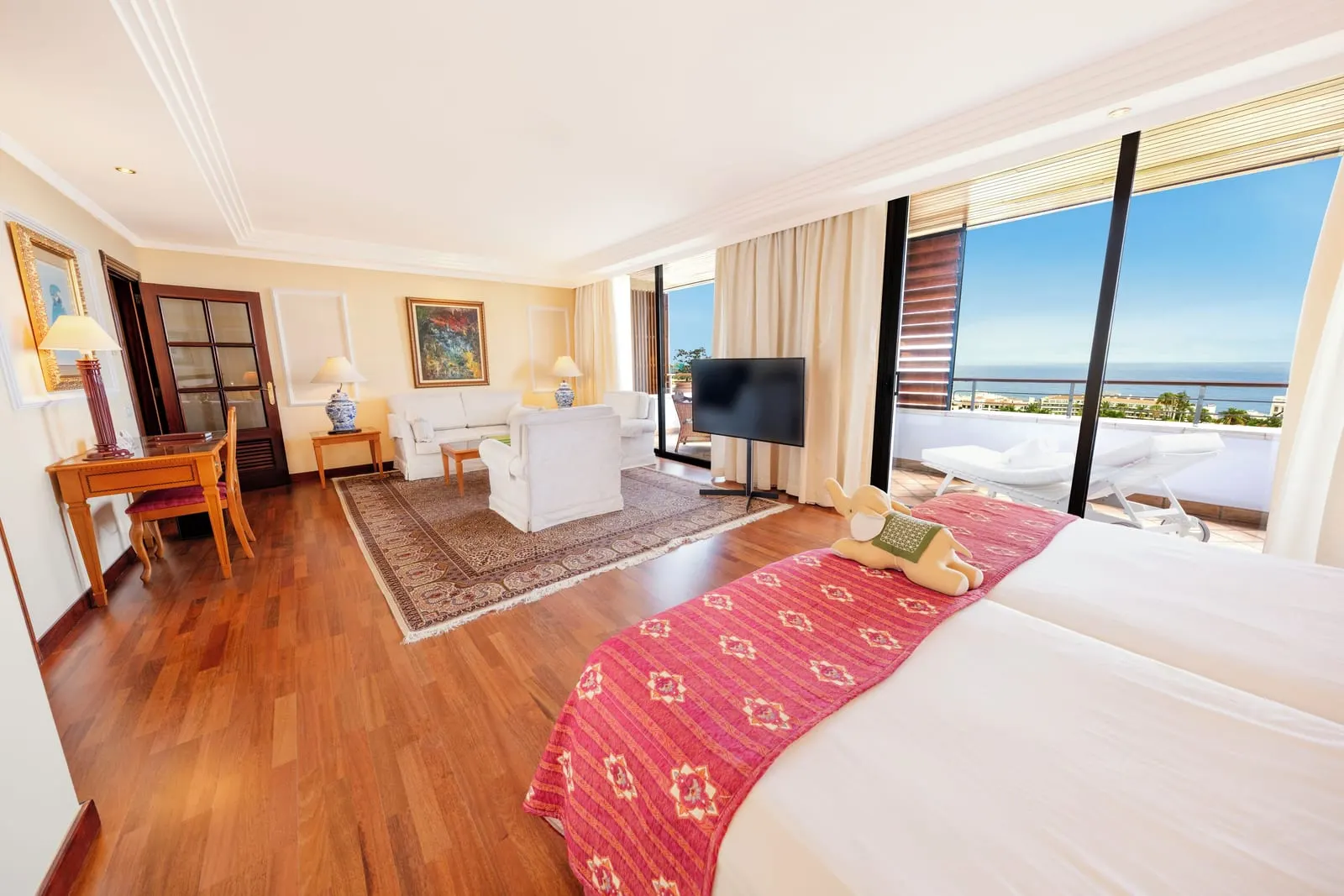 Ambassador Jr. Ocean View Suite at Hotel Botánico: twin beds, a sitting area and tall windows onto the sea