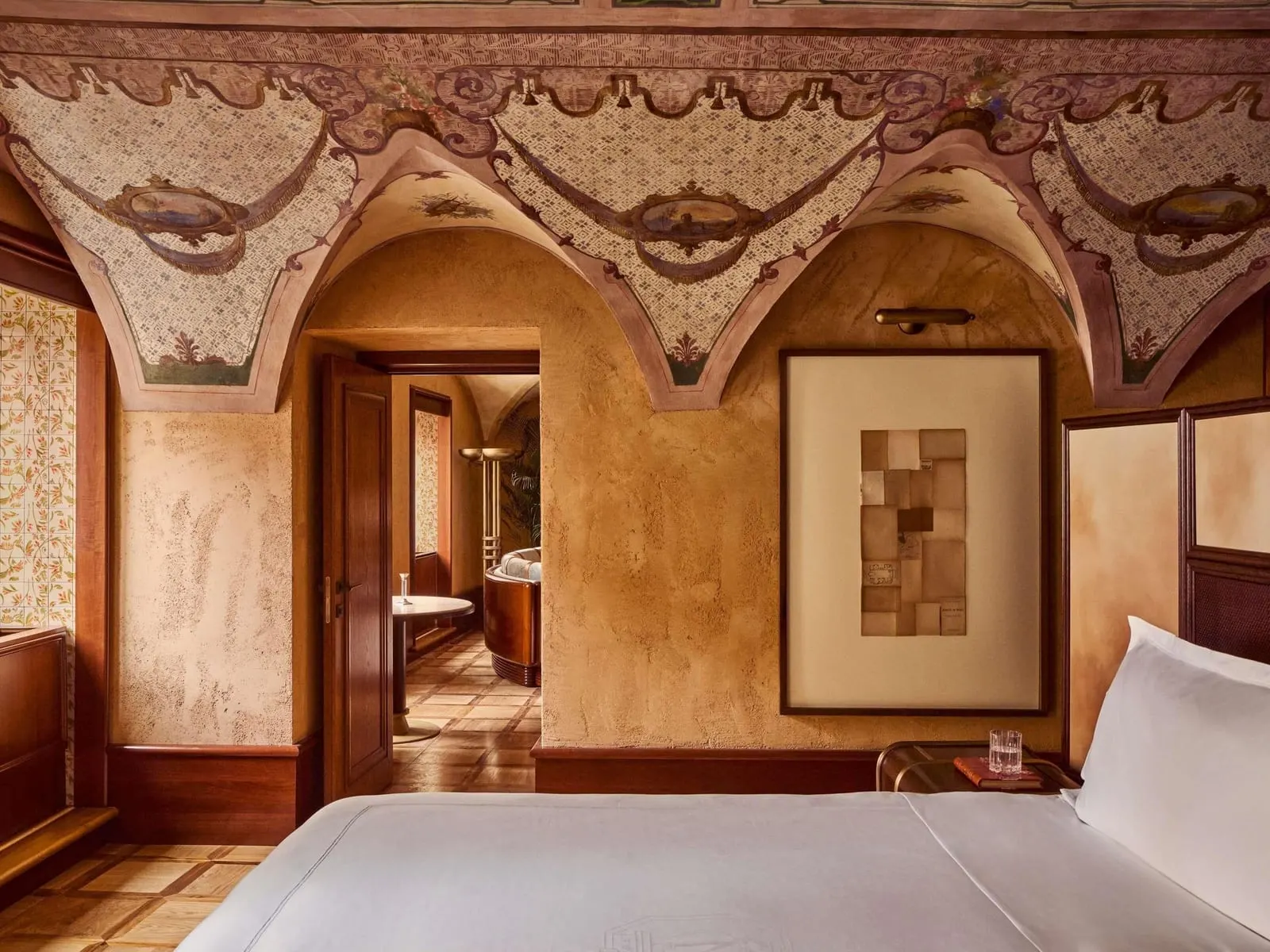 Stendhal Suite at Orient Express La Minerva: the bed under a painted, arched ceiling, with a doorway to the sitting room