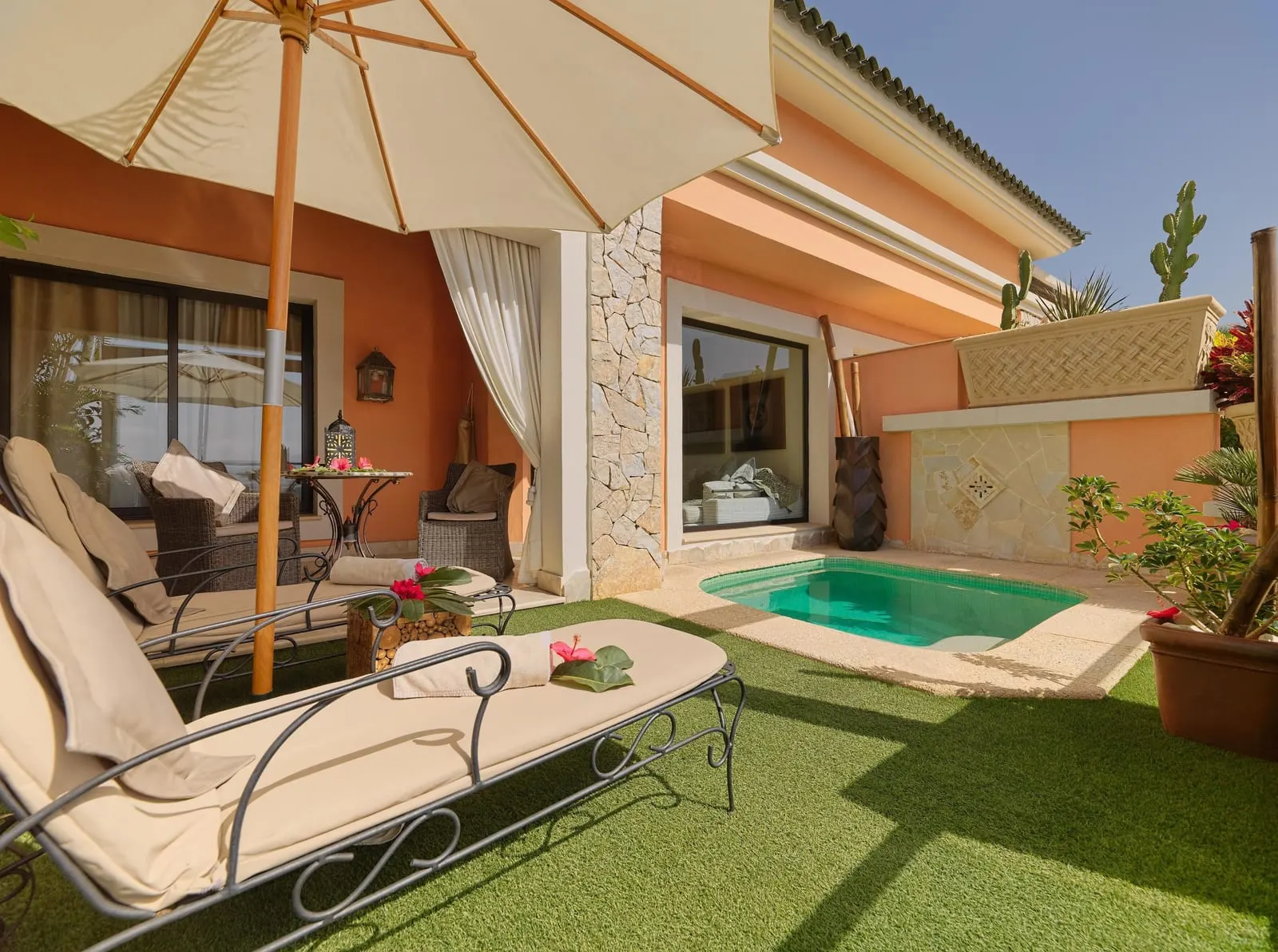 Duchess Villa at Royal Garden Villas: loungers under a parasol on the lawn beside the small plunge pool
