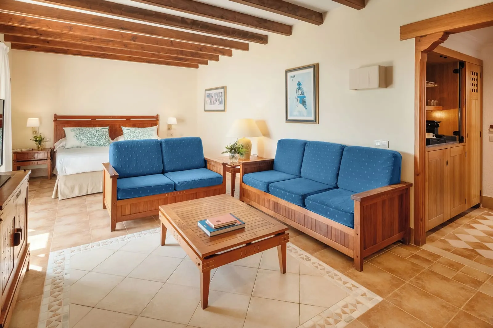 Double Superior Sea View at Princesa Yaiza Suite Hotel Resort: a double bed behind a blue sofa and a sitting area, with a kitchenette alcove