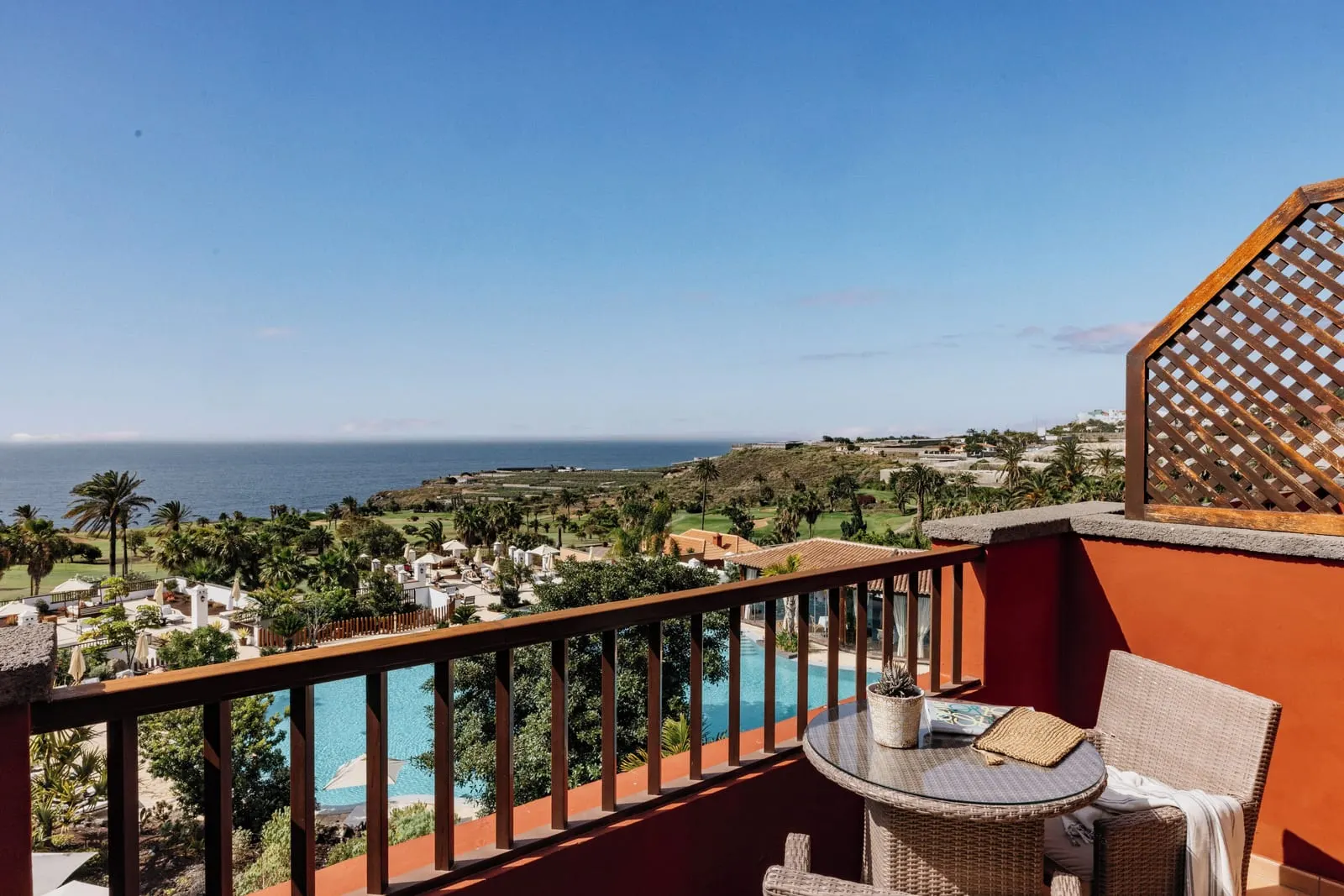 Singular Junior Suite Sea View with Panoramic Terrace at Hacienda del Conde: the terrace table over pools and the coast
