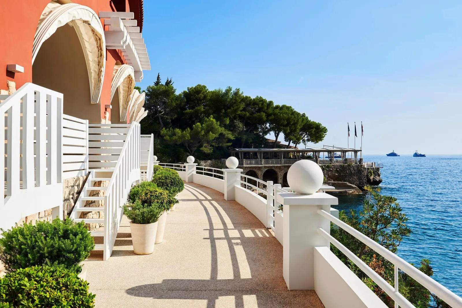 Exclusive Superior Room at Monte-Carlo Beach: white steps down to the seafront promenade, pines and the sea beyond