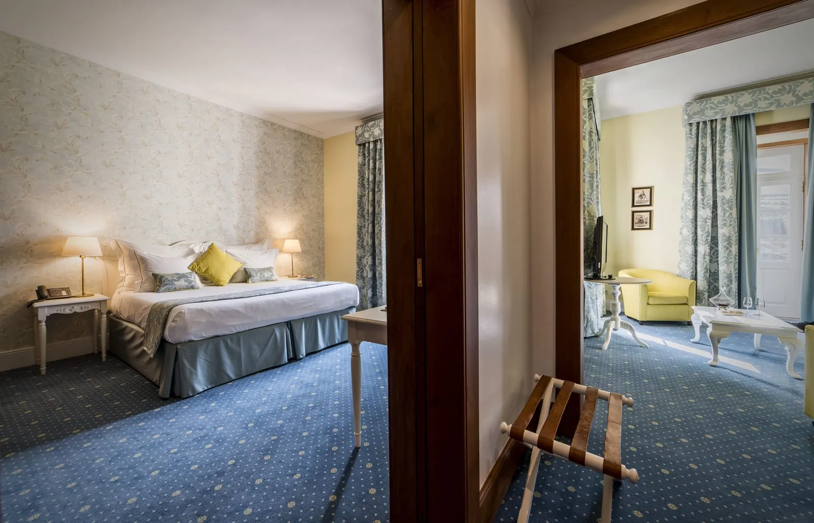 Deluxe Suite Douro River View at The Vintage House: the bedroom, with the separate lounge through a wide doorway