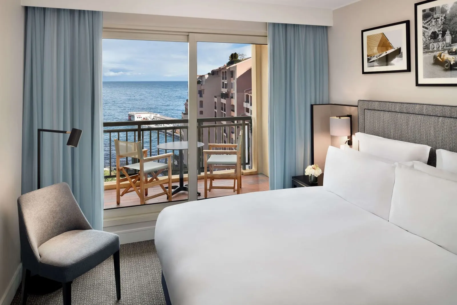 Queen Lifestyle Suite at Columbus Hotel Monte-Carlo: the bed and glass doors to a terrace facing the sea