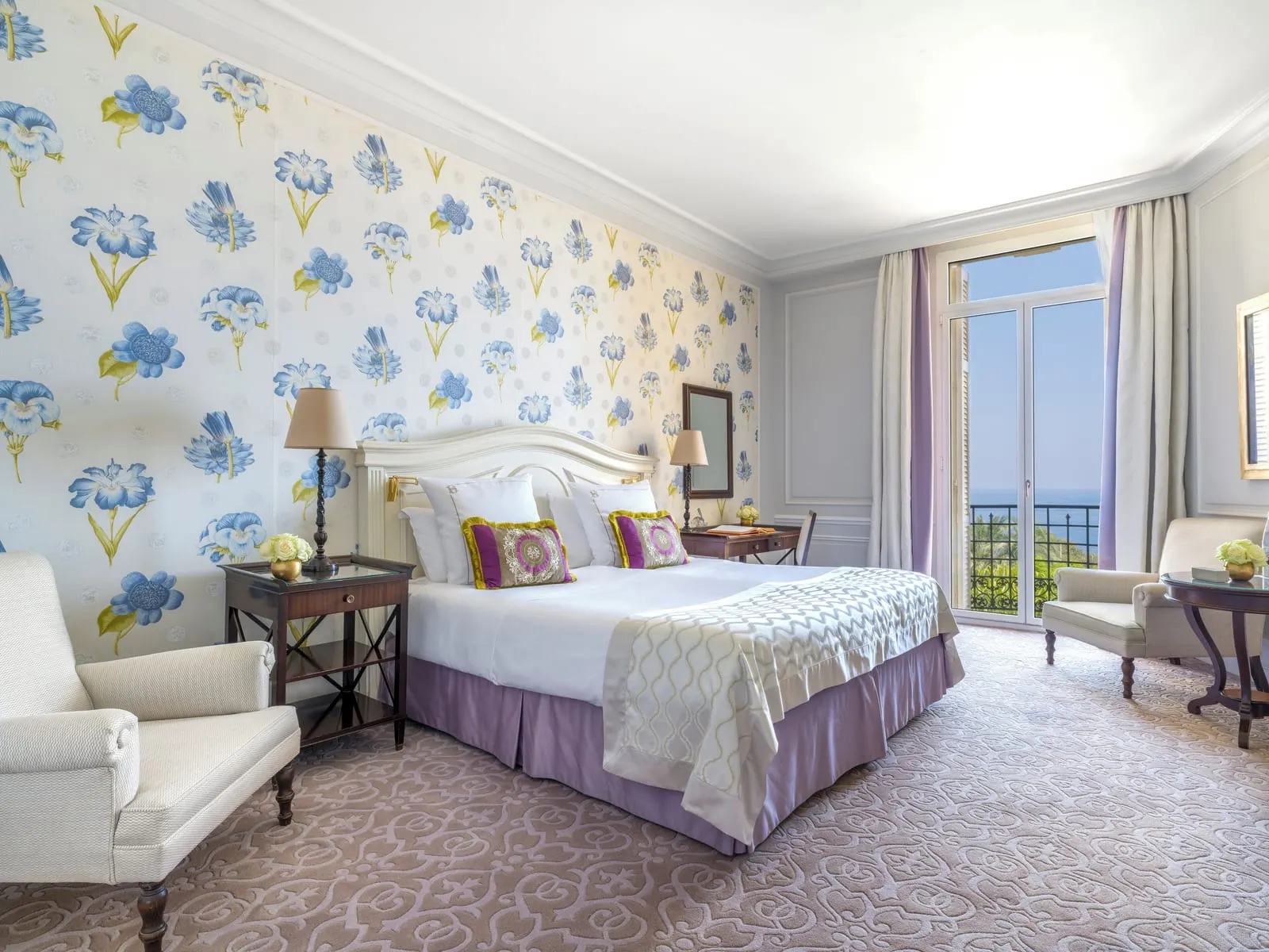 Exclusive Room with sea view at Hôtel Hermitage Monte-Carlo: the bed against floral wallpaper and French windows to the sea