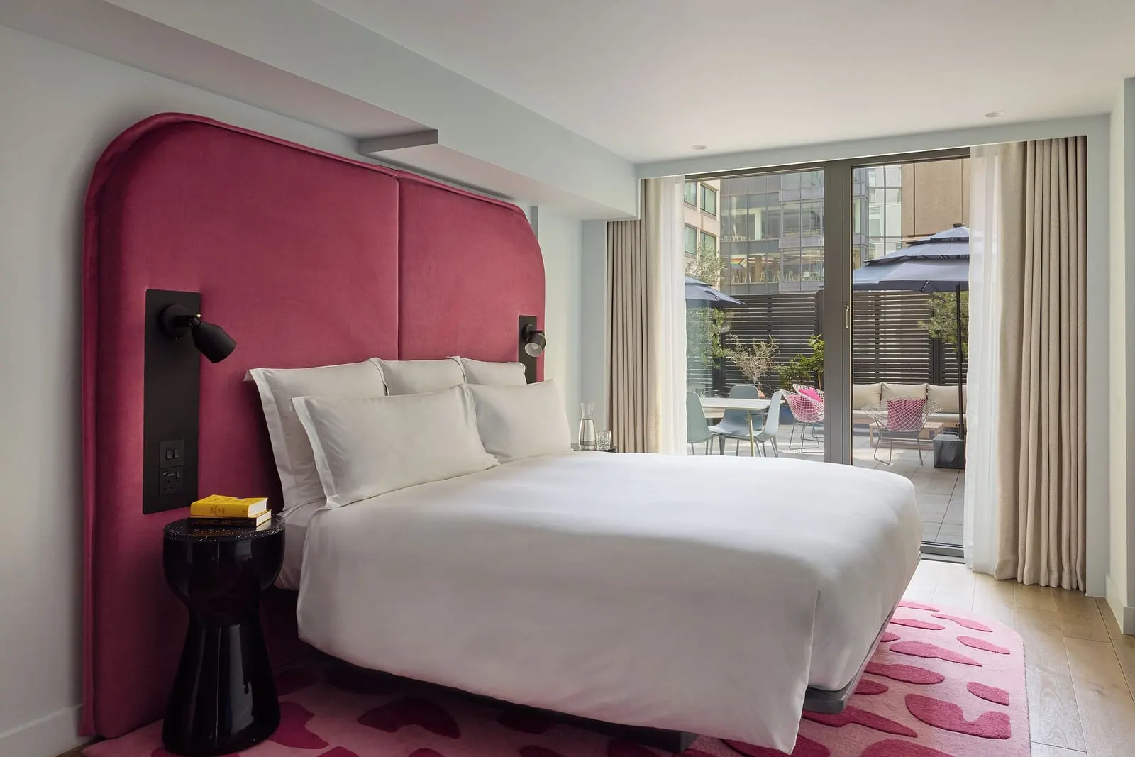 One Bedroom Patio Suite at Sea Containers London: the bed with a red headboard and glass doors onto the patio