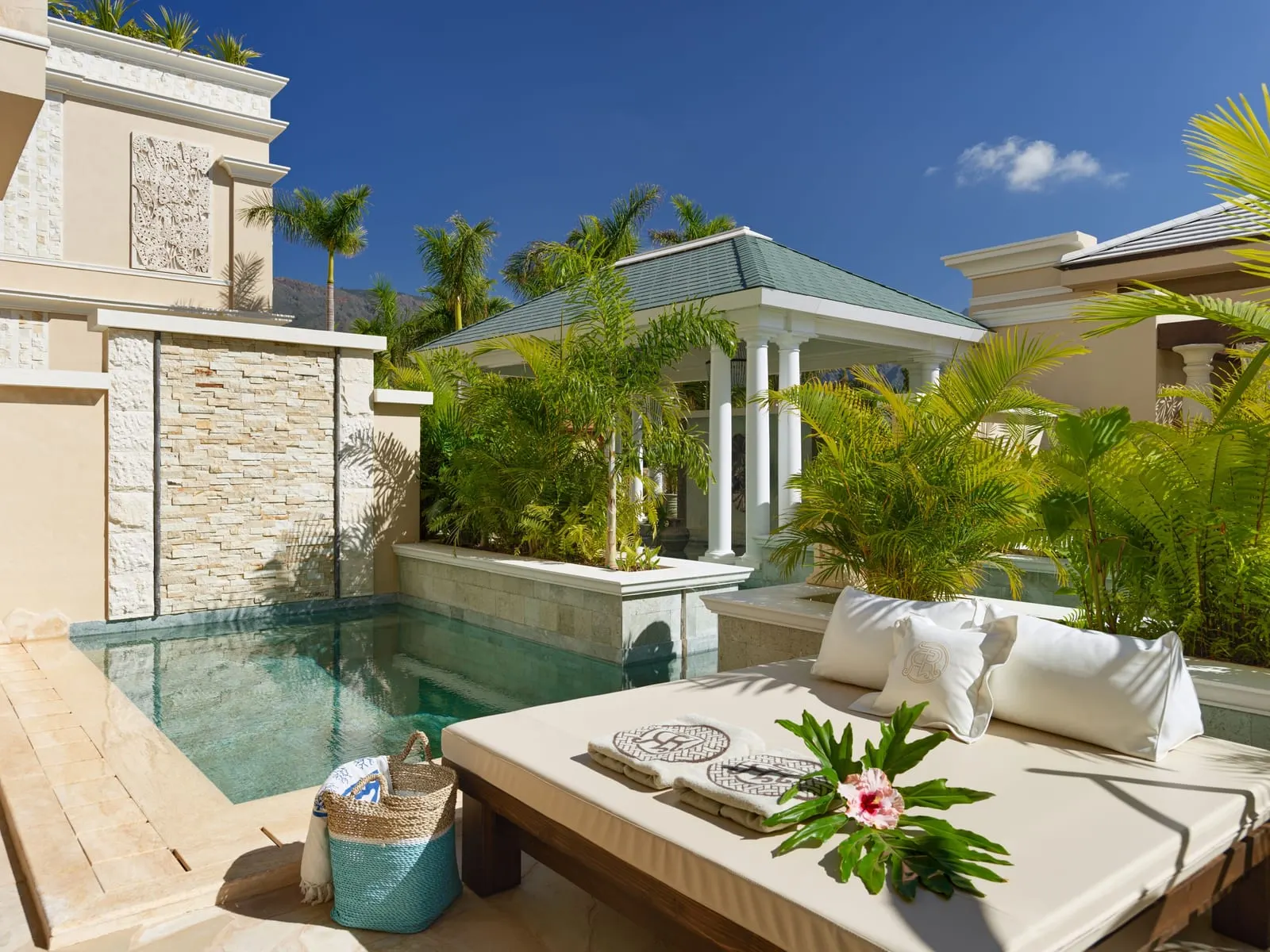 One-bedroom River Villa at Royal River: the private pool, a daybed and a white pavilion among palms