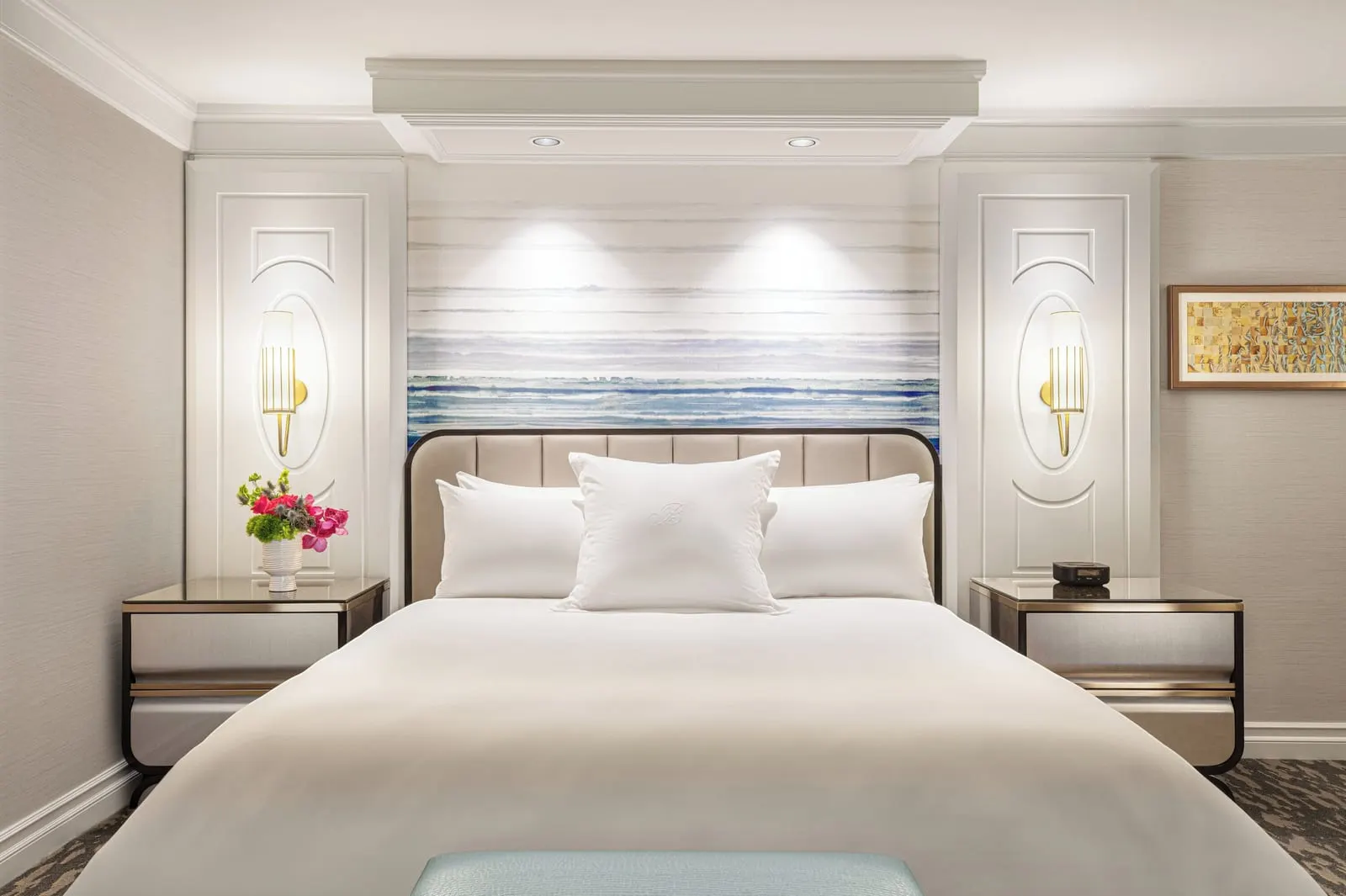 Spa Premier King at Bellagio: a king bed with a padded headboard, a blue and white wave-pattern panel above it and a bedside table on each side