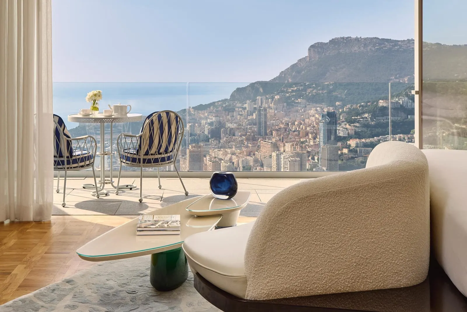 Panoramic Sea View Studio at The Maybourne Riviera: an armchair by the window, with the terrace and Monaco below