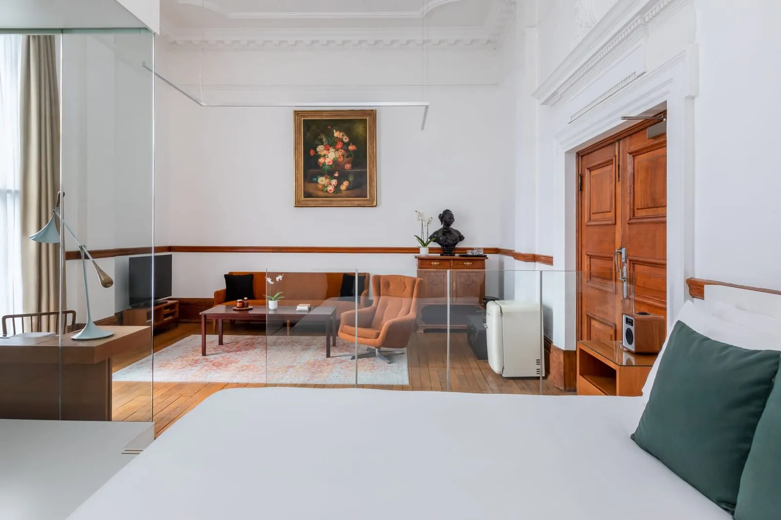 Deluxe Double Room at Town Hall Hotel: the bed, a glass partition, a period wooden door and a desk area