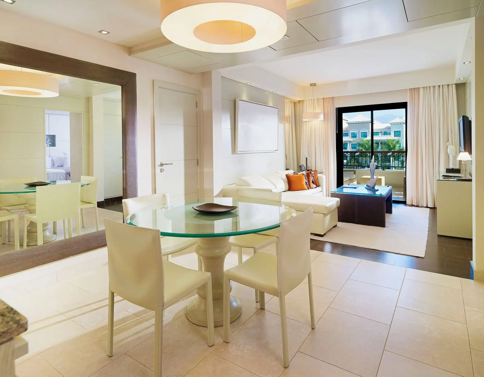RedLevel Master Suite Two Bedrooms with Resort Views at Gran Meliá Palacio de Isora: a dining table, a sofa and the balcony