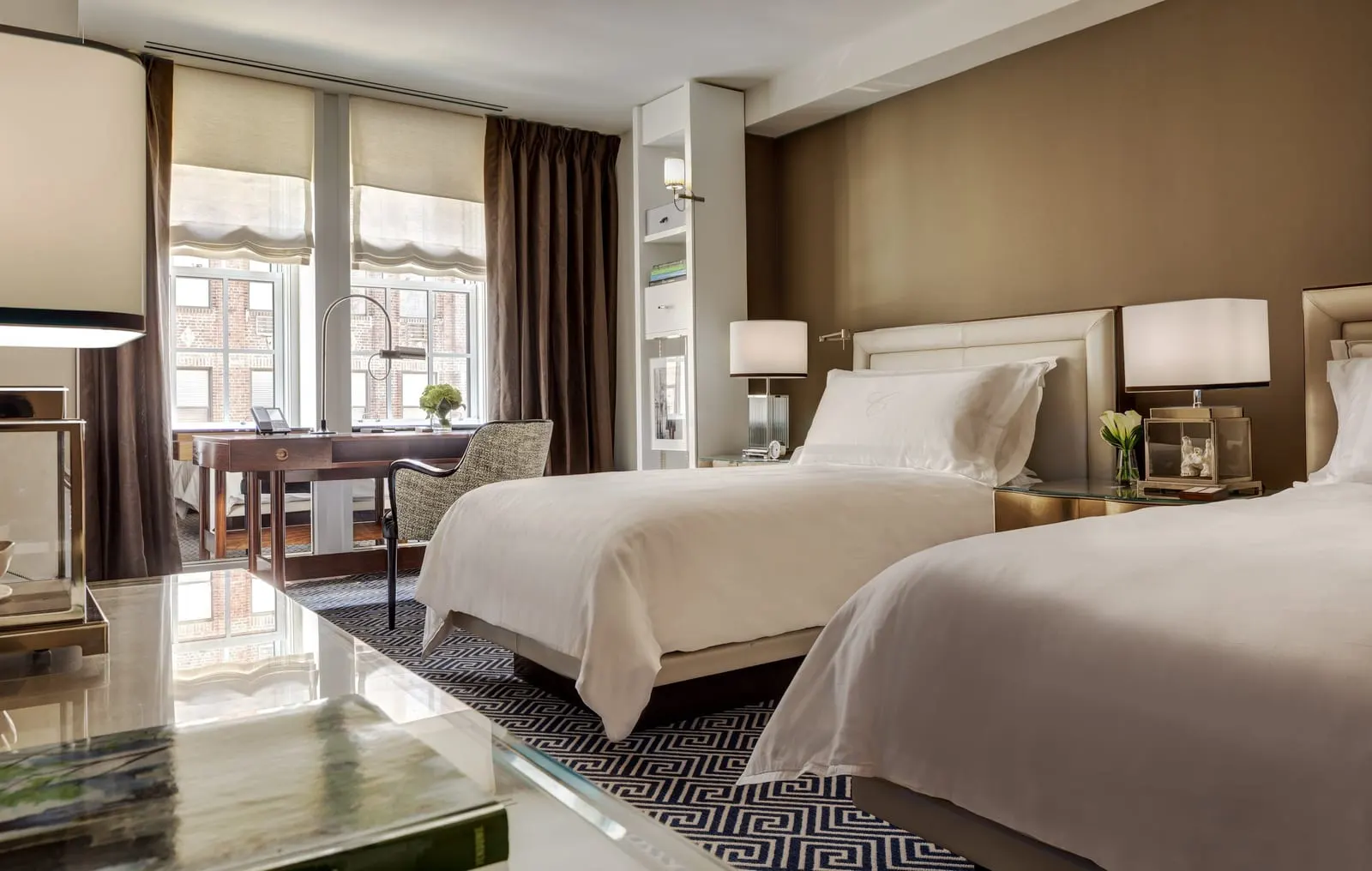 Deluxe Twins Room at The Carlyle: two single beds with white linen and a writing desk in front of two tall windows