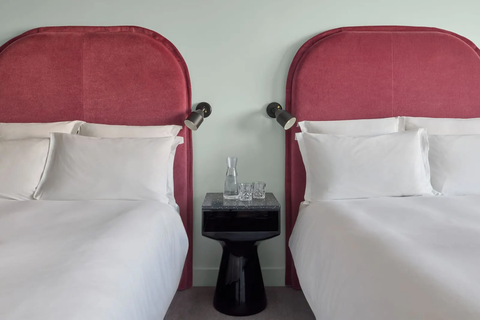 Family Rooms at Sea Containers London: two double beds with red headboards and a shared bedside table