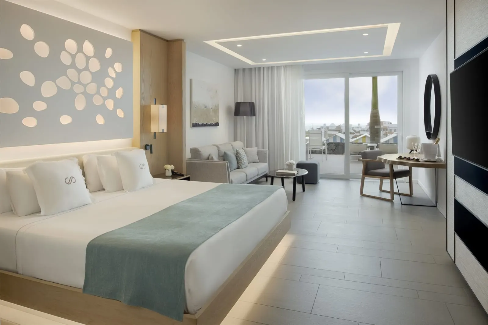 Junior Suite with Outdoor Hot Tub at Royal Hideaway Corales Beach: the bed, a sofa and glass doors to the terrace