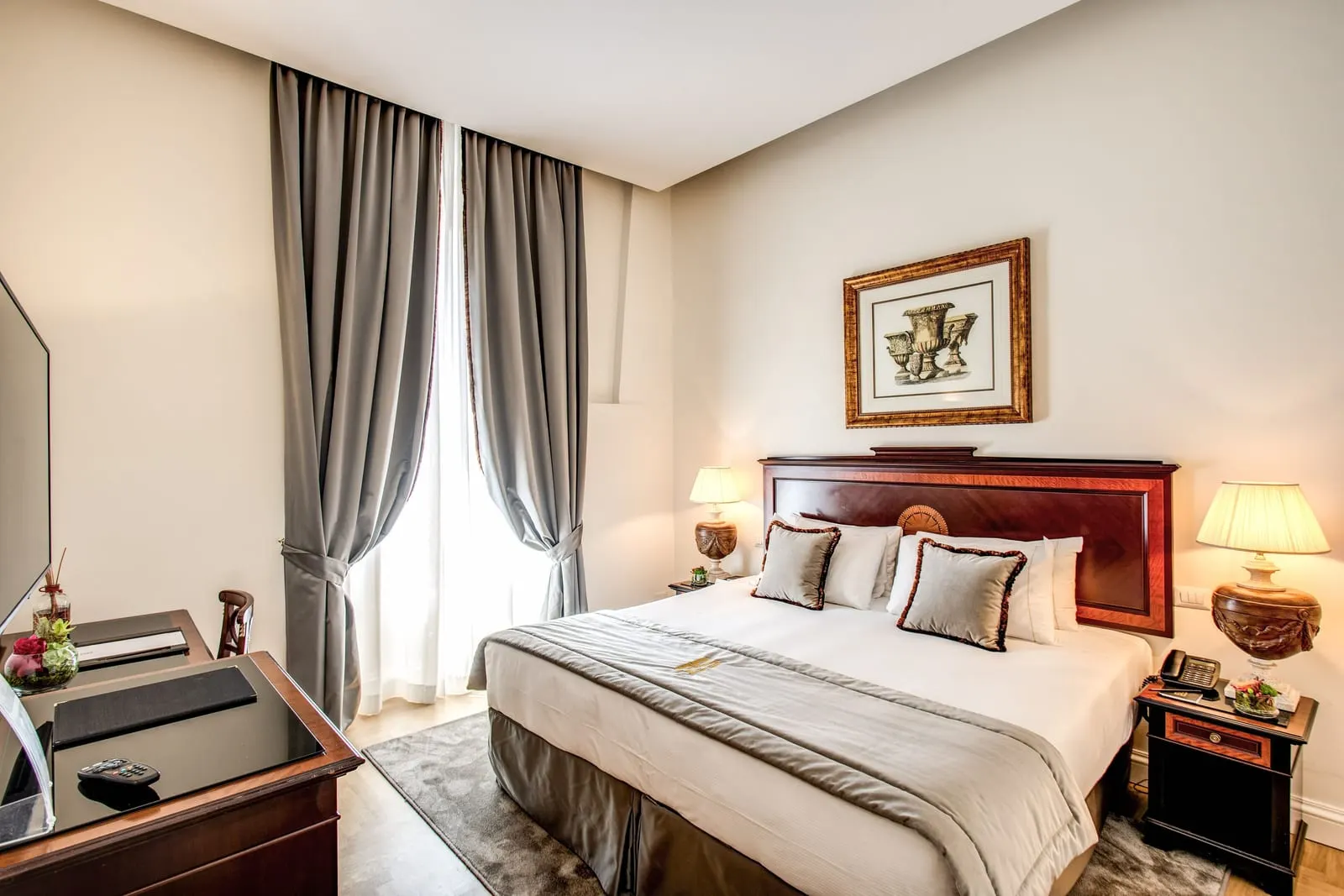 Classic Room at Eitch Borromini Palazzo Pamphilj: a double bed with a walnut headboard, bedside lamps and a desk