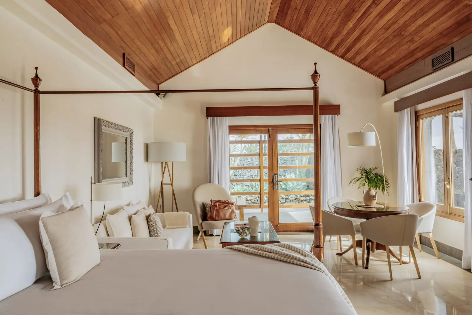 The Reserve Garden Villa at Paradisus Salinas Lanzarote: a bedroom under a timber ceiling with a bed and glazed doors
