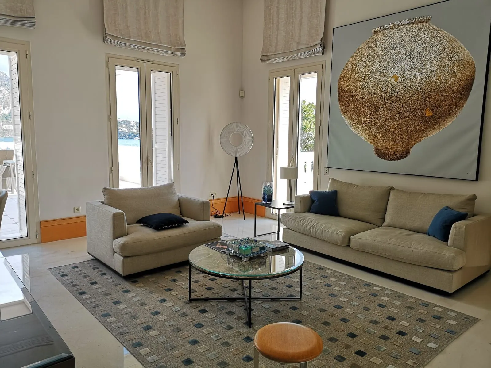 Le Cap Junior Suite with Mezzanine at Cap Estel: the high-ceilinged lounge with two sofas and tall windows
