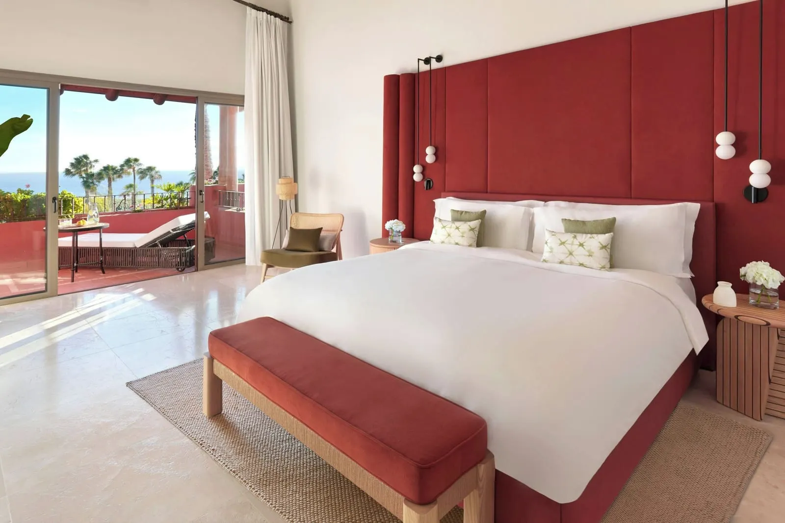 Retreat One Bedroom Suite, Ocean View at the Ritz-Carlton Abama: the bedroom, a king bed, a red bench and terrace doors