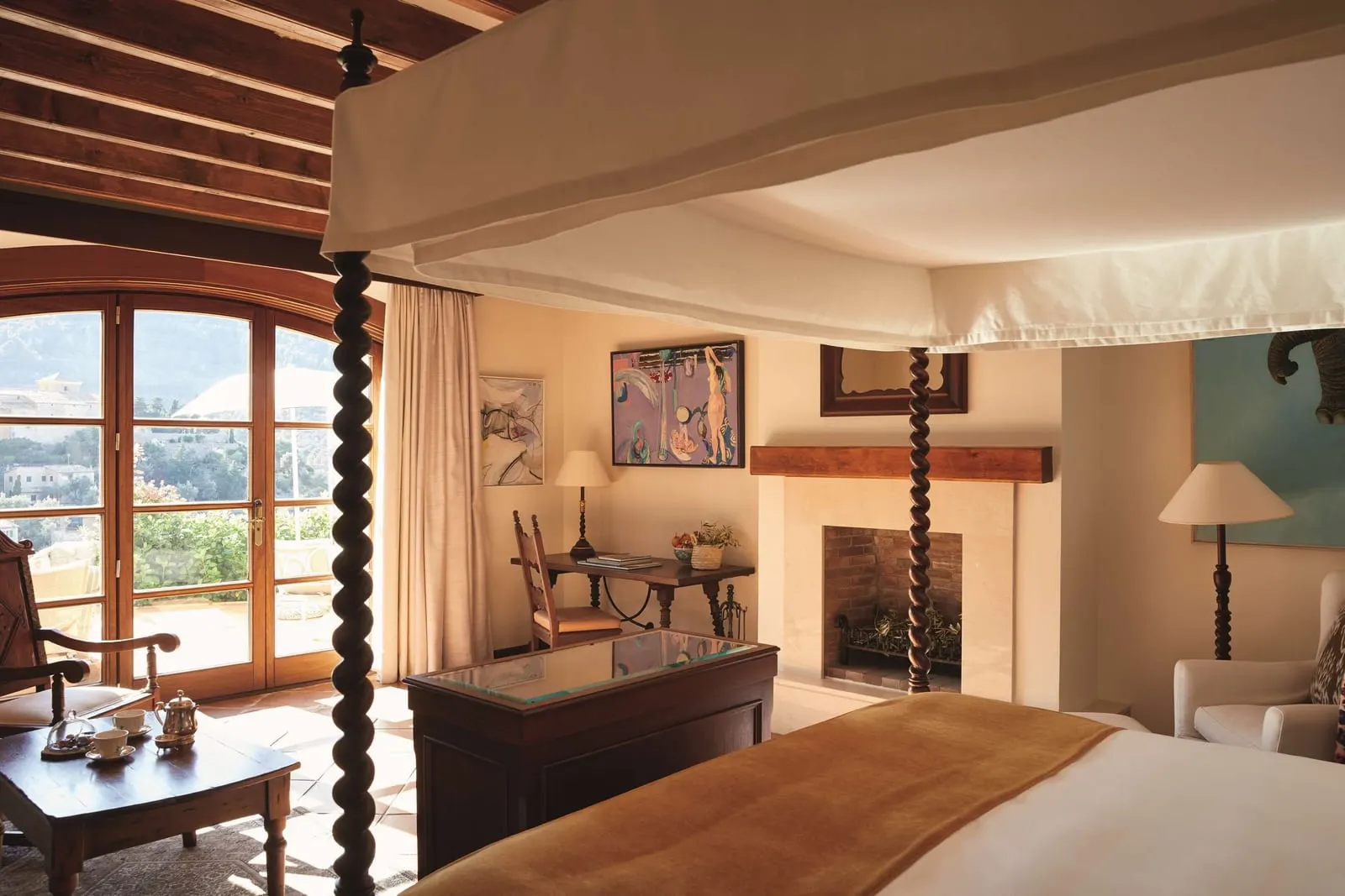 La Residencia, A Belmond Hotel: A Deluxe Junior Suite, with its four-poster and fireplace