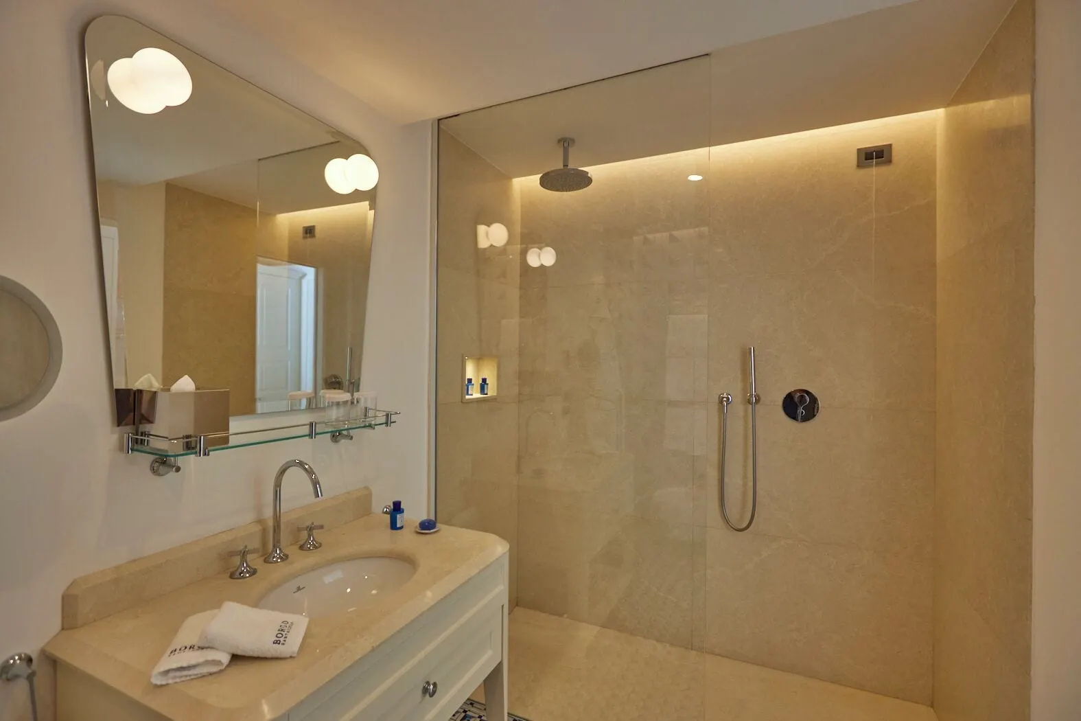 Deluxe Room Sea View & balcony at Borgo Santandrea: a marble bathroom with a walk-in rain shower and a single basin.