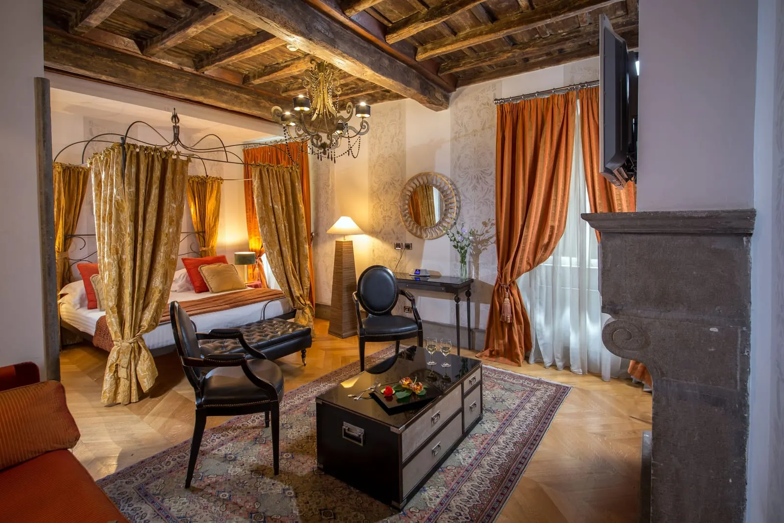 Rooftop Garden Suite (2 Rooms) at The Inn at the Roman Forum: a canopy bed, a stone fireplace and a black trunk table