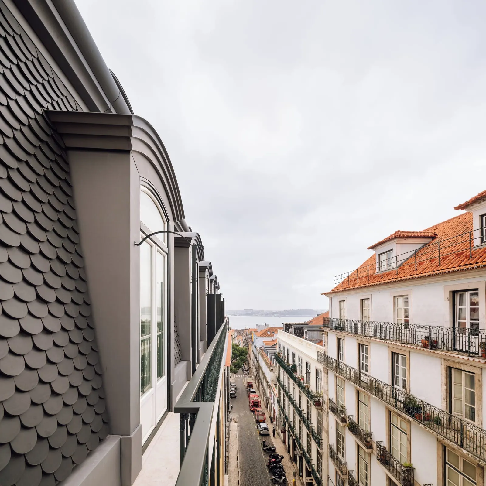 The view from a Prestige Chiado room at Bairro Alto Hotel: a narrow street of balconied houses running down to the river