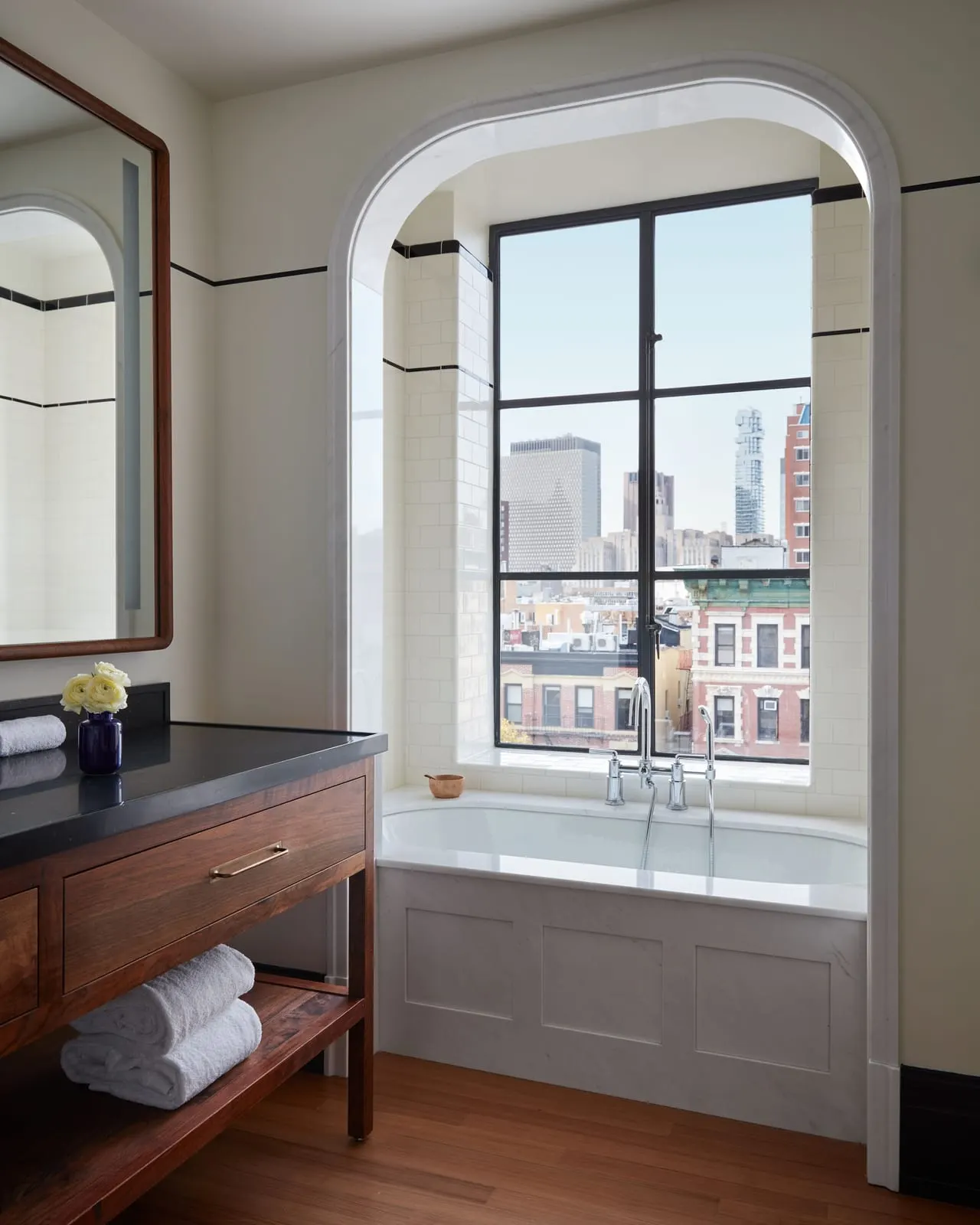 Nine Orchard: A bathroom with a city window