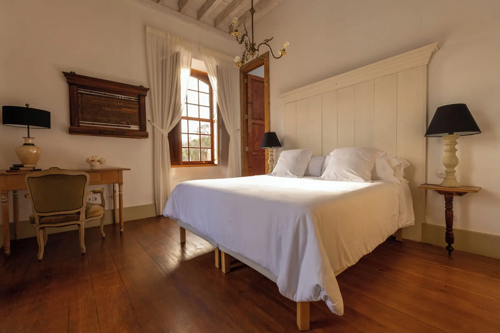 Room 6 Double w/ terrace at La Casa de los Naranjos: a double bed with a white headboard and a writing desk by a shuttered window