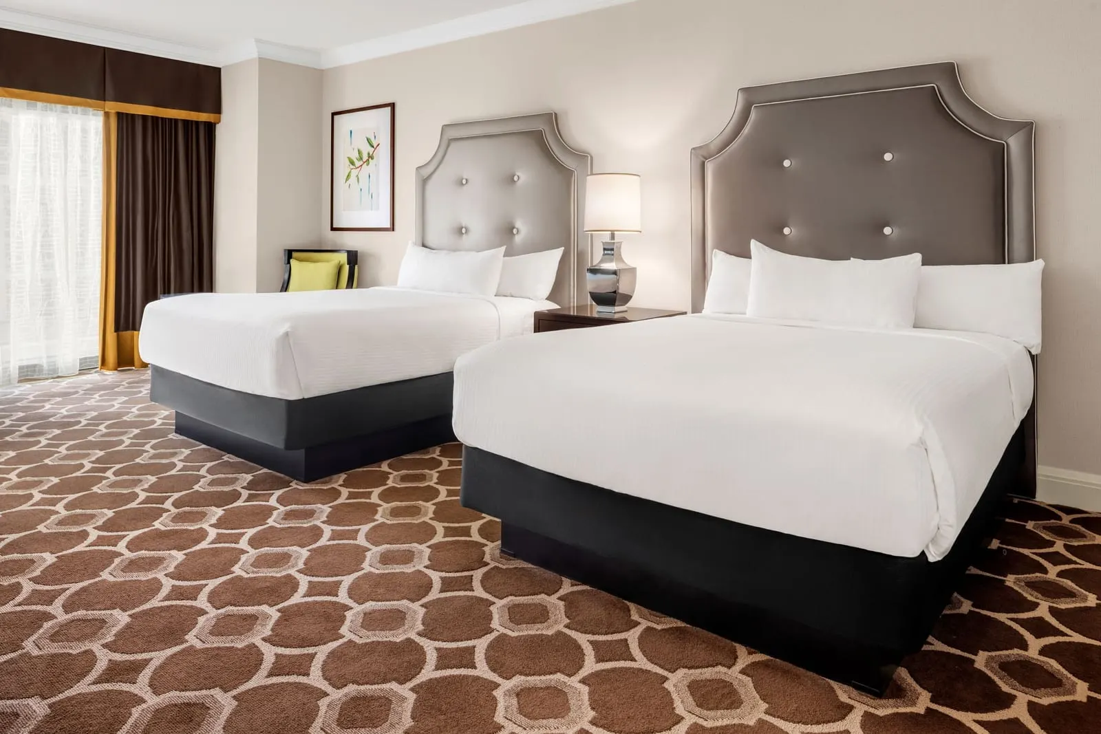 Octavius Pool View Room at Caesars Palace: two queen beds with grey tufted headboards and a lamp between them