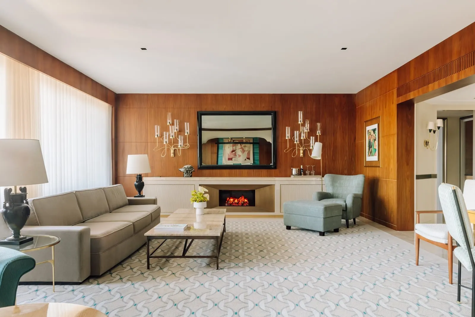 Almada Negreiros Suite at Four Seasons Ritz Lisbon: the living room, with wood panelling, a fireplace and a sofa