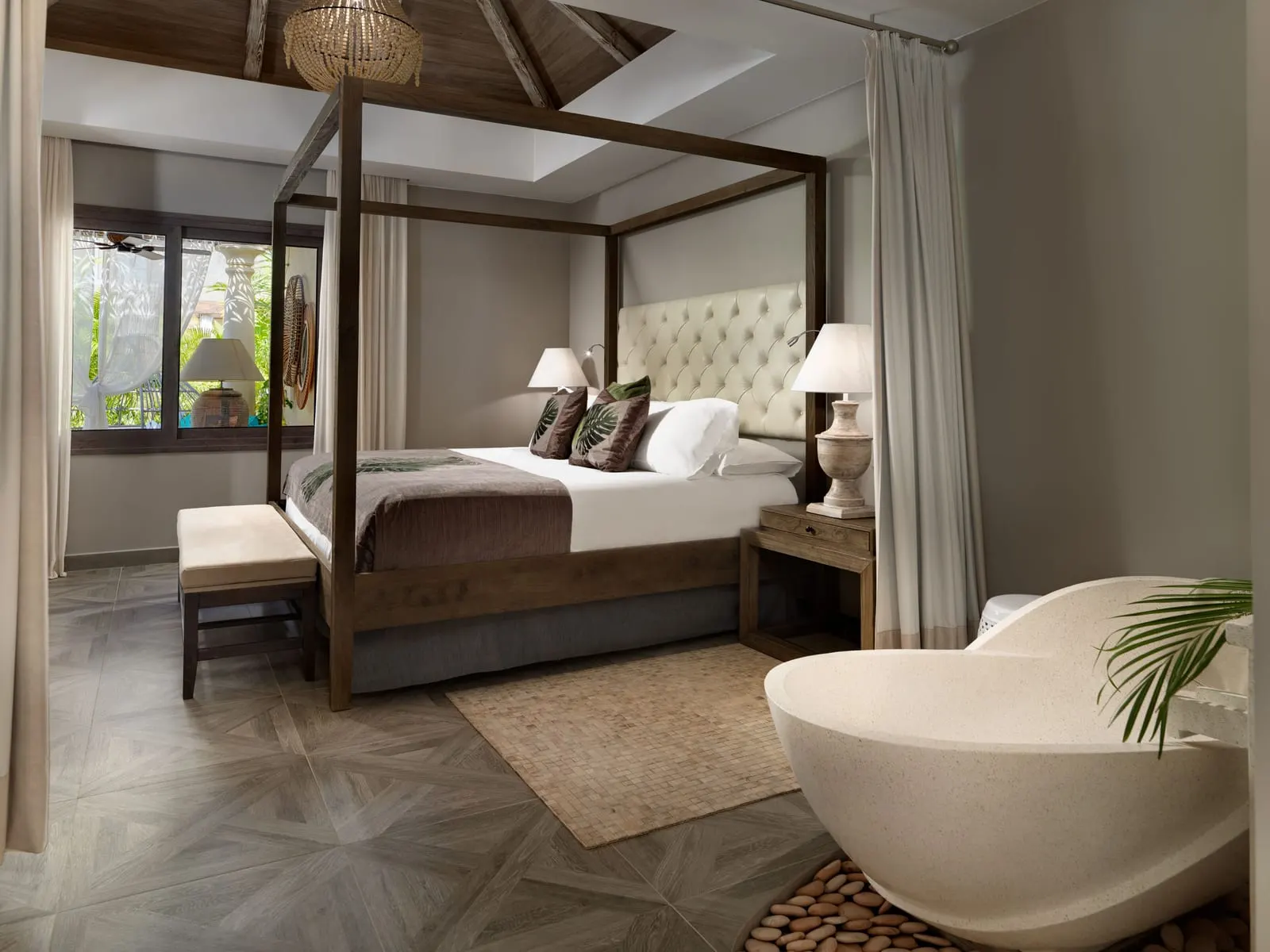 Two-bedroom River Villa at Royal River: a four-poster bed and a freestanding bath in the same room